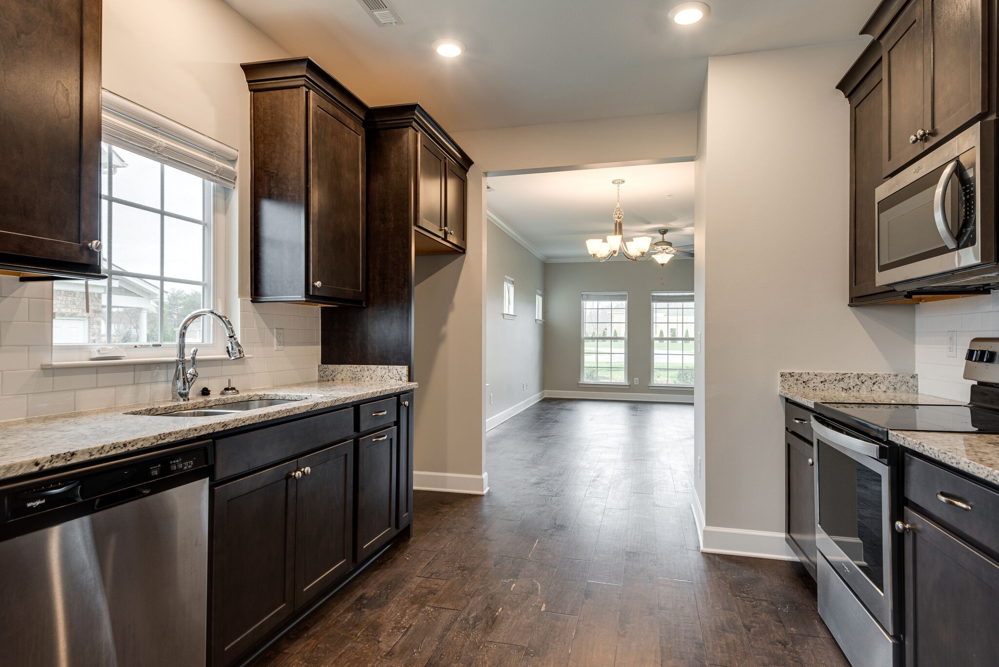 269 Mary Ann Circle Spring Hill, TN 37174 - Photo 11 of 28 a kitchen with stainless steel appliances granite countertop a sink a stove and a wooden floors