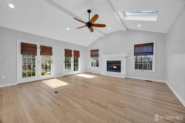 a view of an empty room with a fireplace and a window