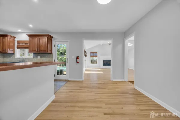 a kitchen with stainless steel appliances granite countertop a refrigerator a sink a stove and oven