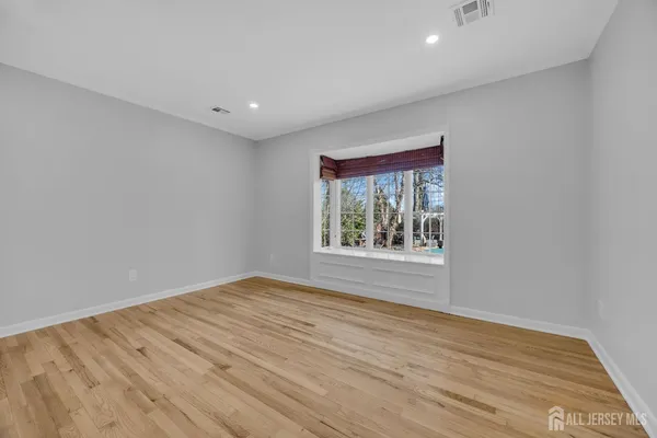 a bathroom with a granite countertop sink a toilet a mirror and bathtub