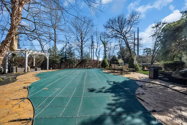 a view of a patio with couches table and chairs and potted plants