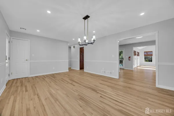 a view of an empty room with a fireplace and a window