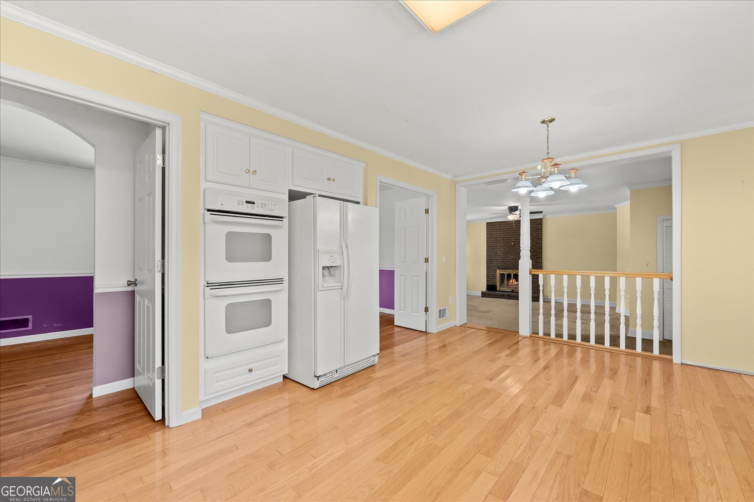 110 Riverside Drive Washington, GA 30673 - Photo 6 of 29 a view of a kitchen with wooden floor and a ceiling fan