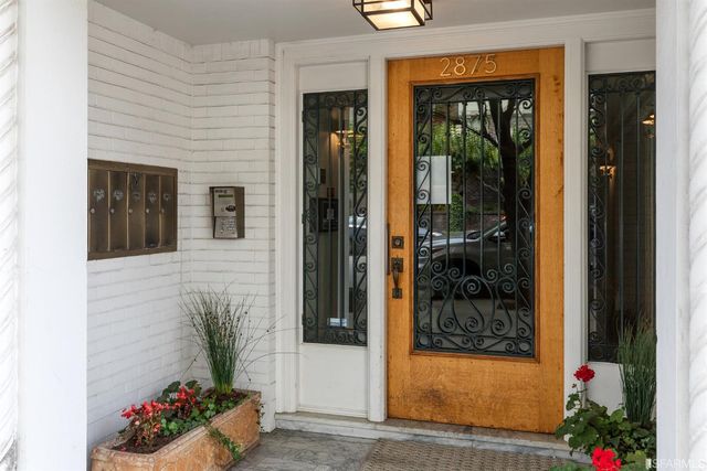 a potted plant sitting in front of a house
