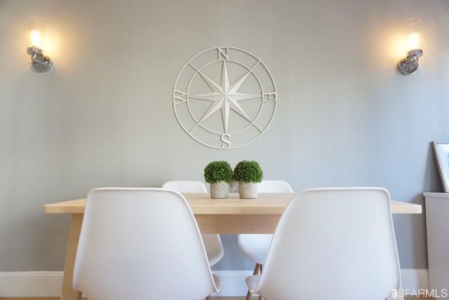 a dining room with table and chairs