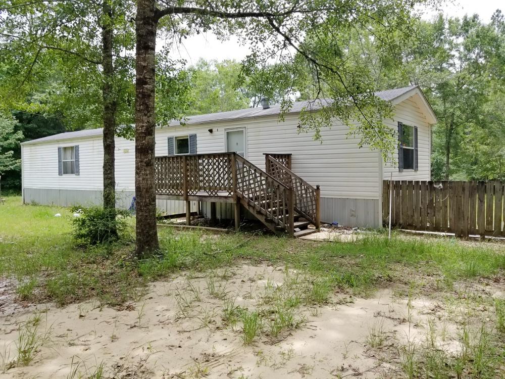 396 Bullard Church Road Baker, FL 32531 - Photo 1 of 8 a view of a house with backyard and a tree