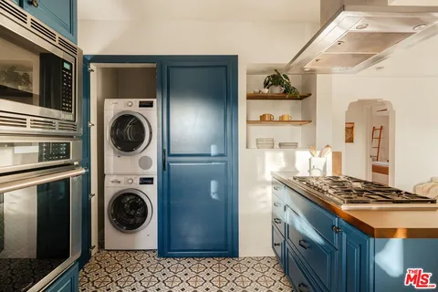a kitchen that has a washer and dryer