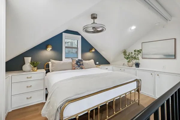 a bedroom with a bed and a flat tv screen on the dresser