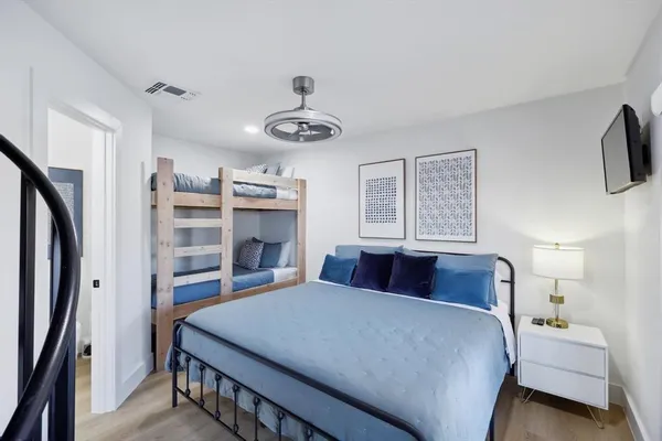 a bedroom with a bed and a mirror