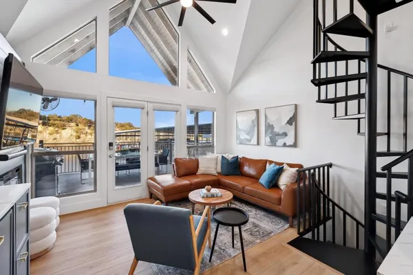 a living room with furniture a rug and a window