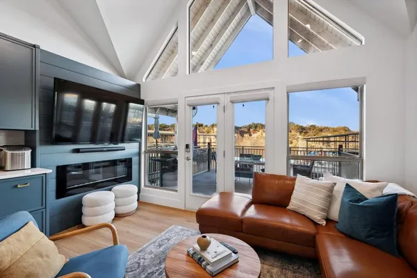 a living room with furniture and a floor to ceiling window