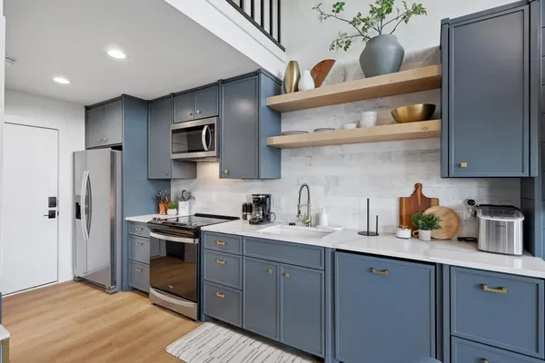 a kitchen with stainless steel appliances granite countertop a stove and a refrigerator