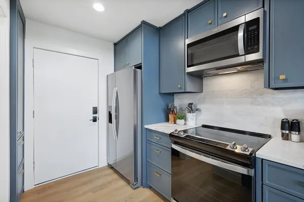a bathroom with a granite countertop sink a toilet and a mirror