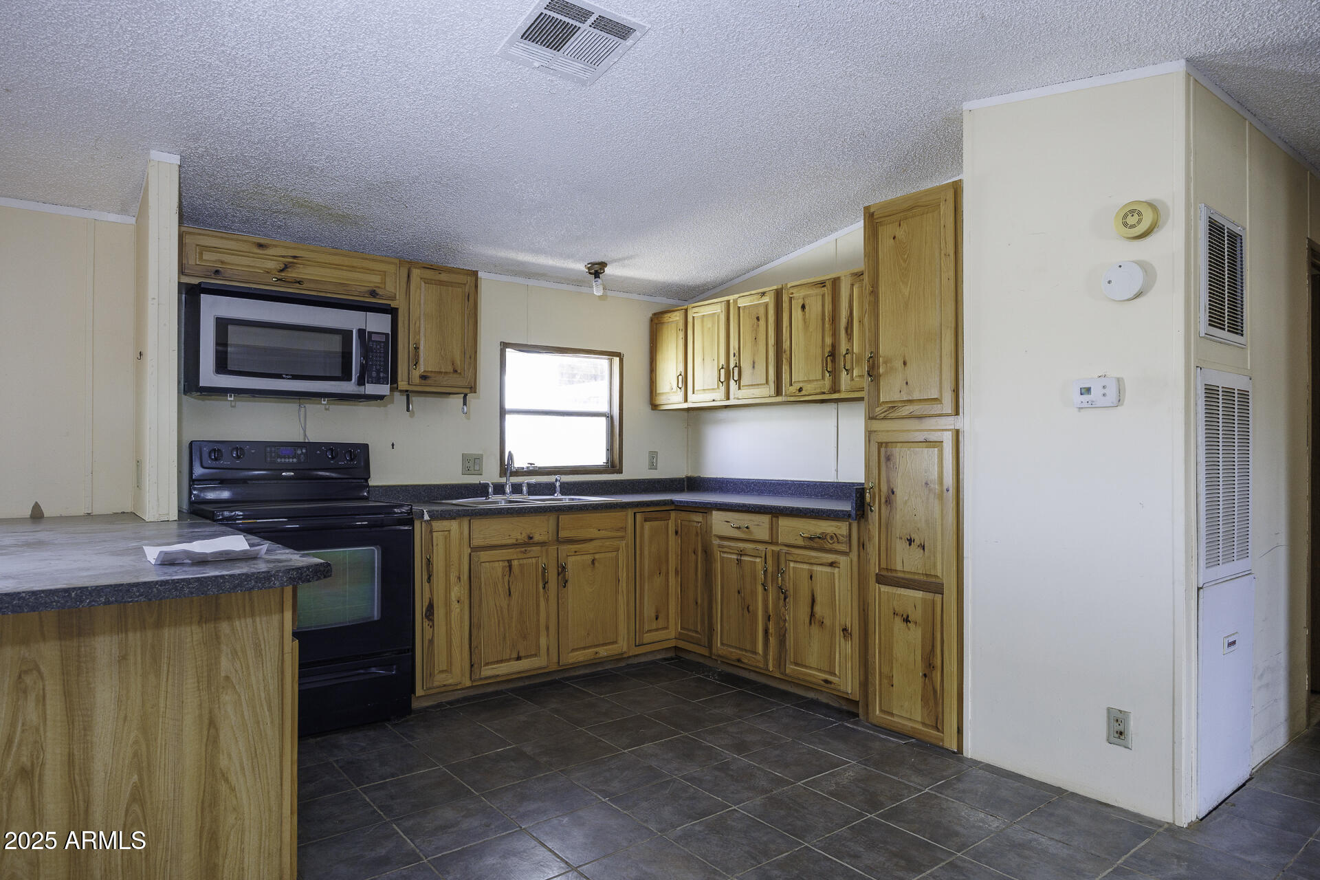 9505 West Milligan Road Arizona City, AZ 85123 - Photo 14 of 45 a kitchen with stainless steel appliances granite countertop a stove a sink and a refrigerator