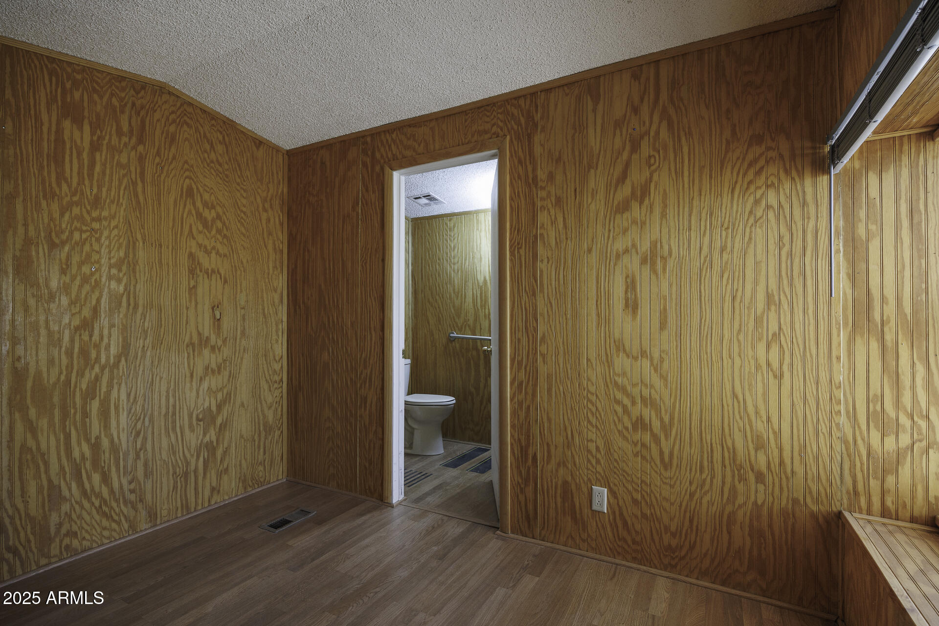 9505 West Milligan Road Arizona City, AZ 85123 - Photo 17 of 45 a view of a hallway with wooden floor