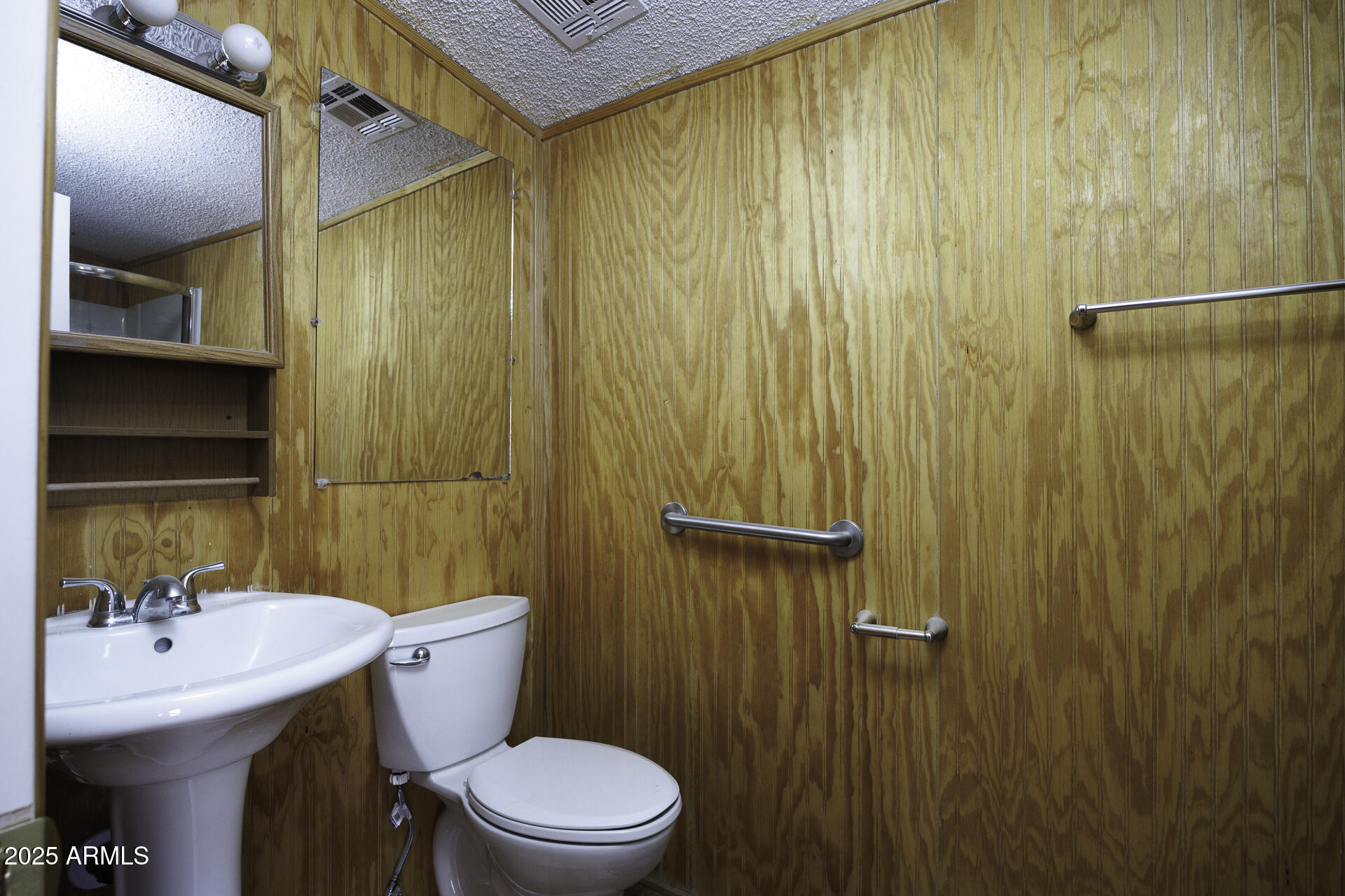 9505 West Milligan Road Arizona City, AZ 85123 - Photo 19 of 45 a bathroom with a sink a toilet and shower curtain