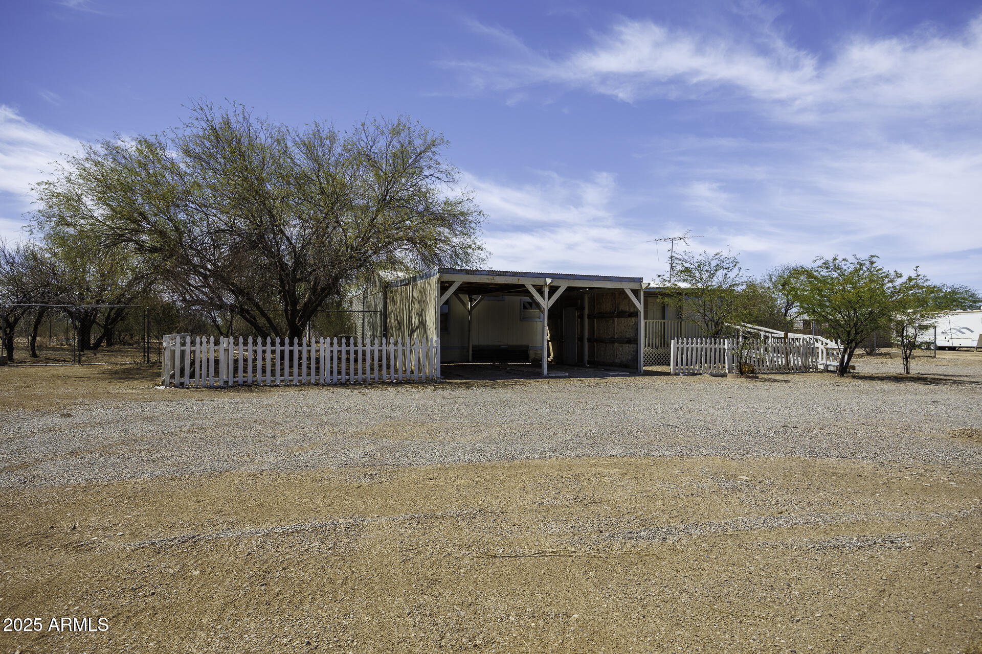 9505 West Milligan Road Arizona City, AZ 85123 - Photo 3 of 45 a front view of a house with a yard and garage