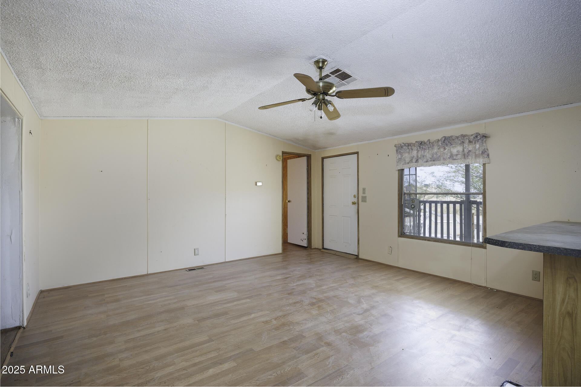 9505 West Milligan Road Arizona City, AZ 85123 - Photo 10 of 45 a view of empty room with wooden floor and fan