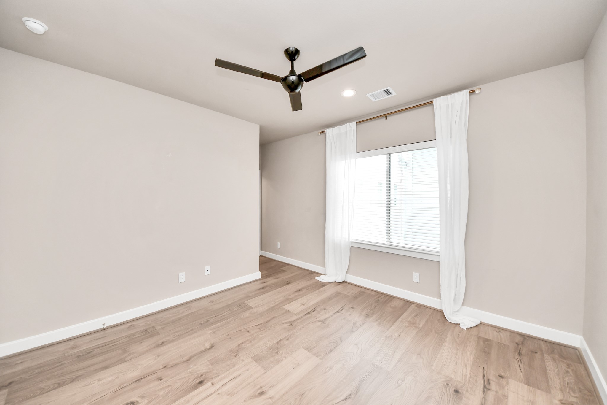 2114 Stuart Street Houston, TX 77004 - Photo 25 of 39 an empty room with wooden floor and windows