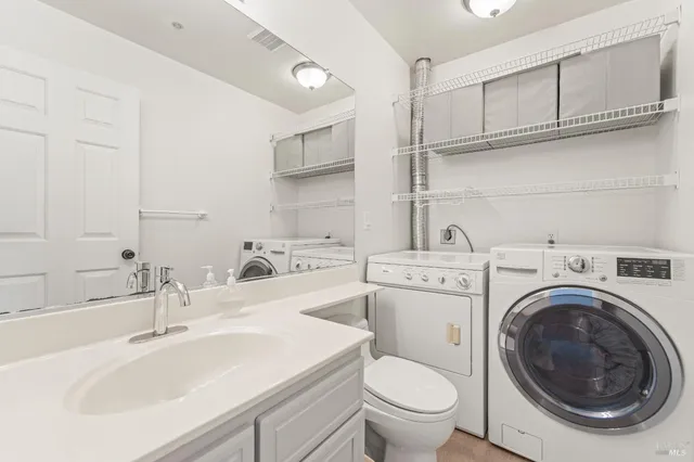 a bathroom with a sink a washer and dryer