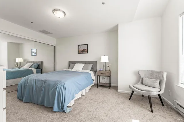 a bedroom with two beds and a couch