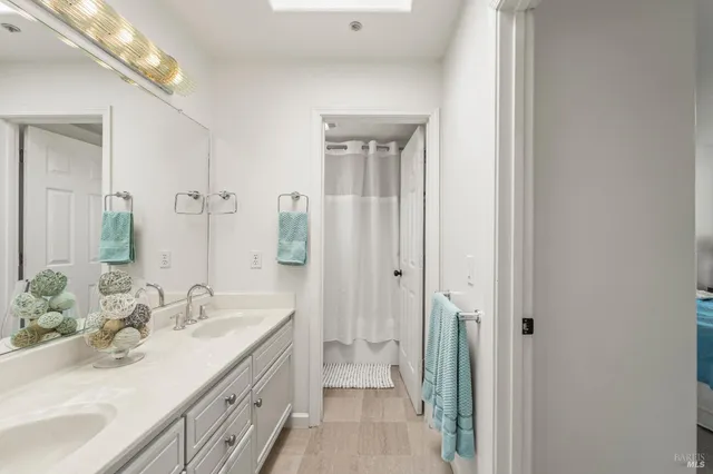 a bathroom with a double vanity sink and a mirror