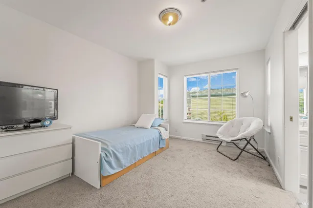 a bedroom with a bed and flat screen tv