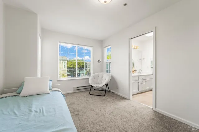 a spacious bedroom with a bed and window