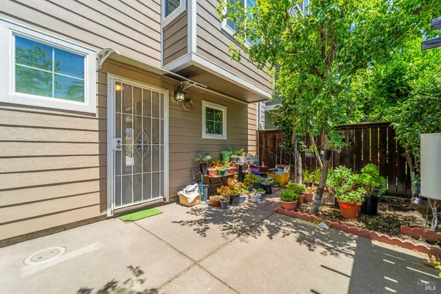 a view of a chair and table in backyard of the house