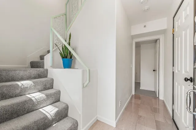 a living room with furniture and stairs