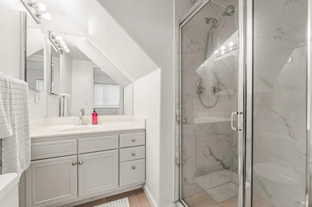 a bathroom with a shower sink and mirror