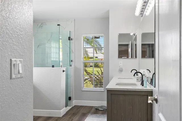 a living room with furniture kitchen view and a chandelier