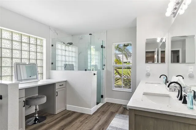 a kitchen with stainless steel appliances granite countertop a dining table chairs and white cabinets