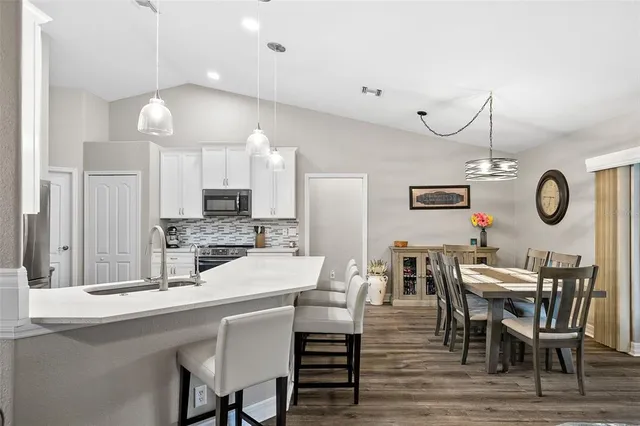a kitchen with a sink cabinets and wooden floor