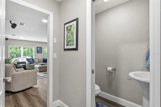 an aerial view of a house with a garden and lake view