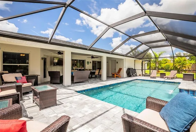 an aerial view of a house with a garden and swimming pool