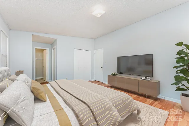 a bedroom with a bed and a flat screen tv