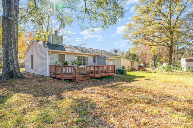 a view of house with backyard and tree