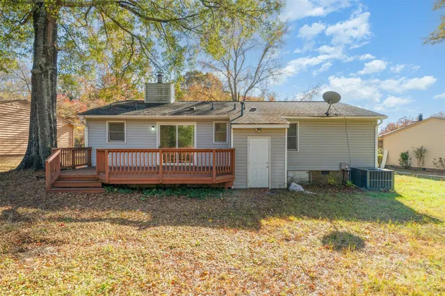 a backyard of a house with barbeque oven table and chairs