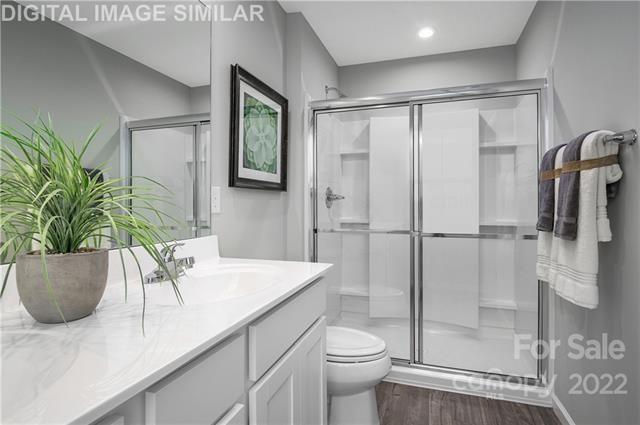 117 Hackamore Road, Unit 208 Troutman, NC 28166 - Photo 13 of 17 a bathroom with a sink a toilet and shower