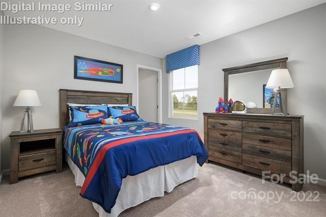 117 Hackamore Road, Unit 208 Troutman, NC 28166 - Photo 14 of 17 a bedroom with a bed and a dresser