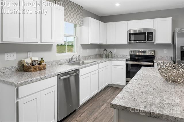 117 Hackamore Road, Unit 208 Troutman, NC 28166 - Photo 4 of 17 a kitchen with granite countertop white cabinets and white appliances