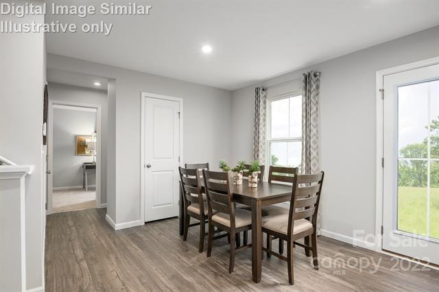 117 Hackamore Road, Unit 208 Troutman, NC 28166 - Photo 9 of 17 a view of a dining room with furniture and wooden floor