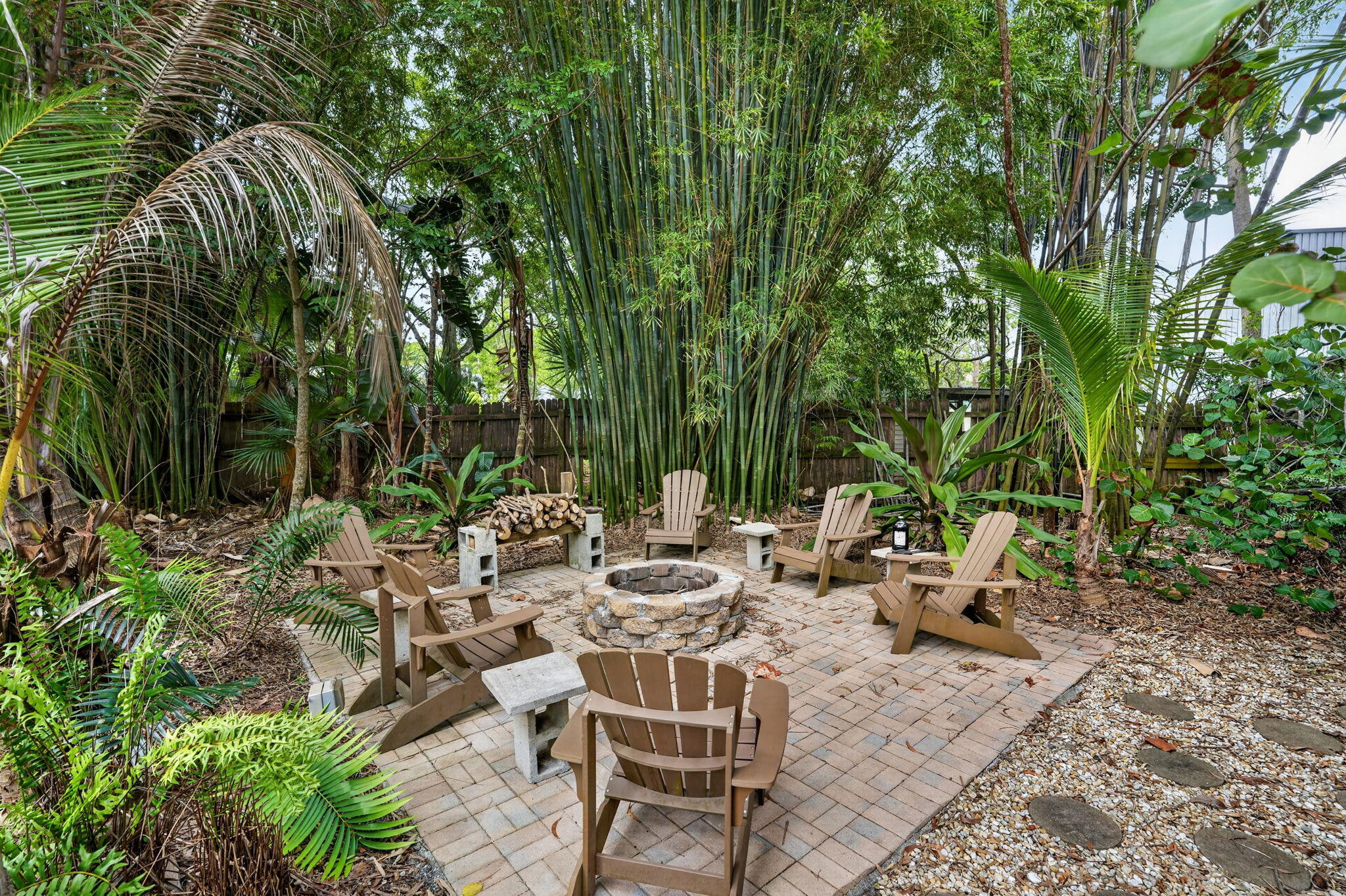 17391 Alexander Run Jupiter, FL 33478 - Photo 42 of 55 a view of a patio with table and chairs potted plants and large tree