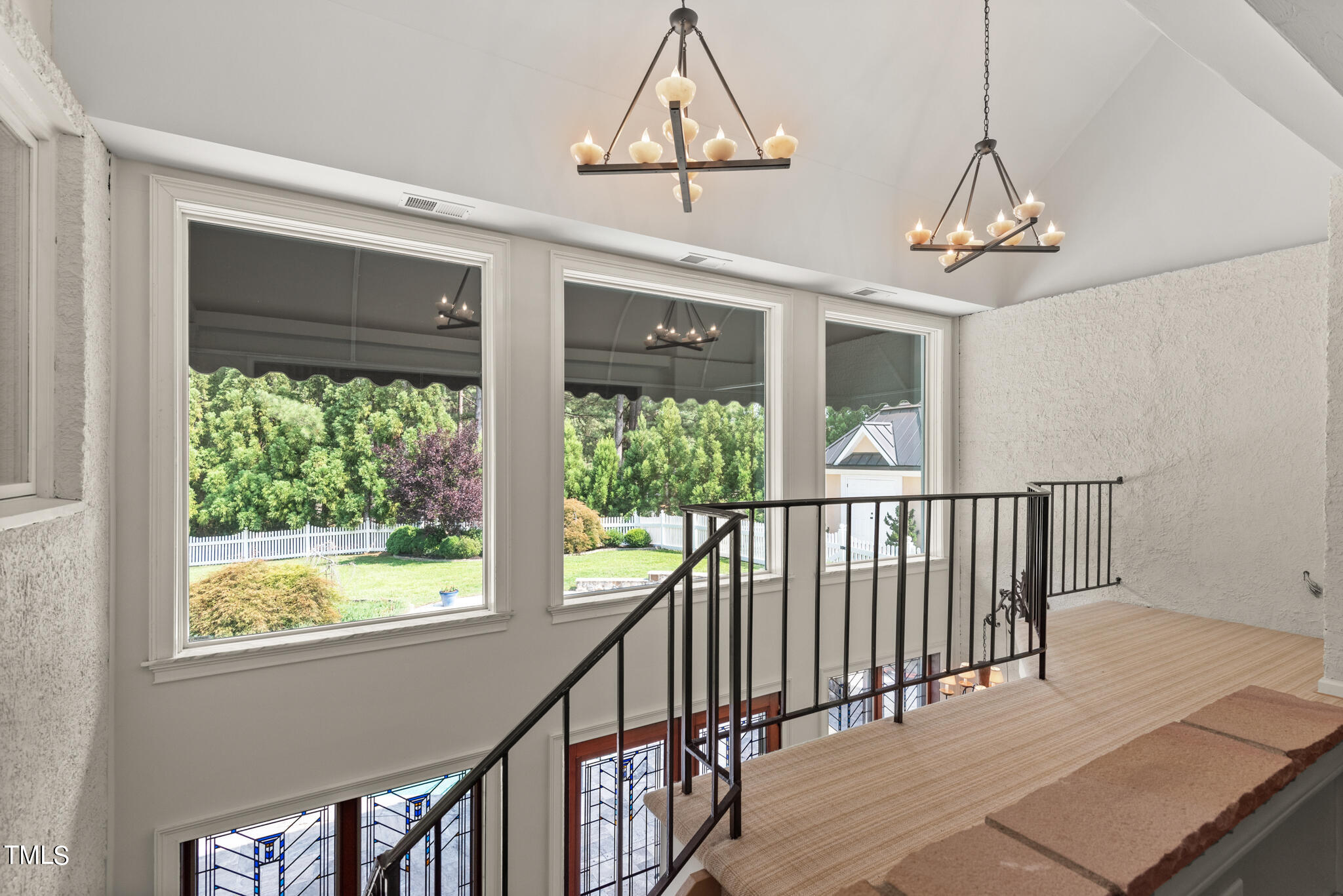 1936 Amethyst Ridge Road Raleigh, NC 27604 - Photo 39 of 74 a view of a room with wooden floor windows and a chandelier