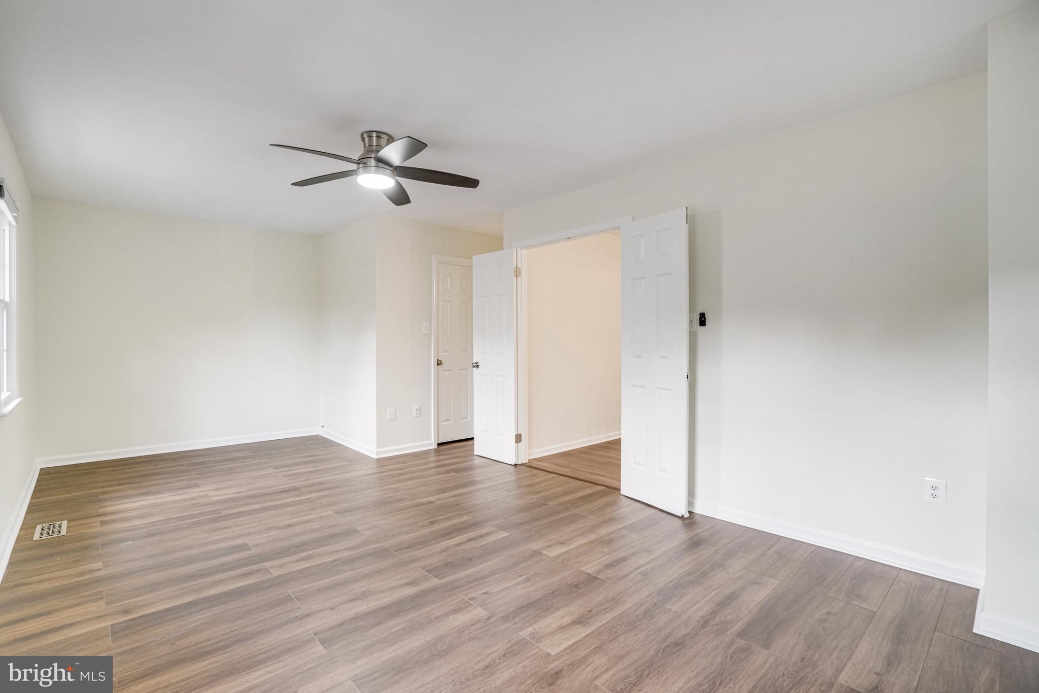 2266 Cartbridge Road Falls Church, VA 22043 - Photo 27 of 48 an empty room with wooden floor ceiling fan and windows