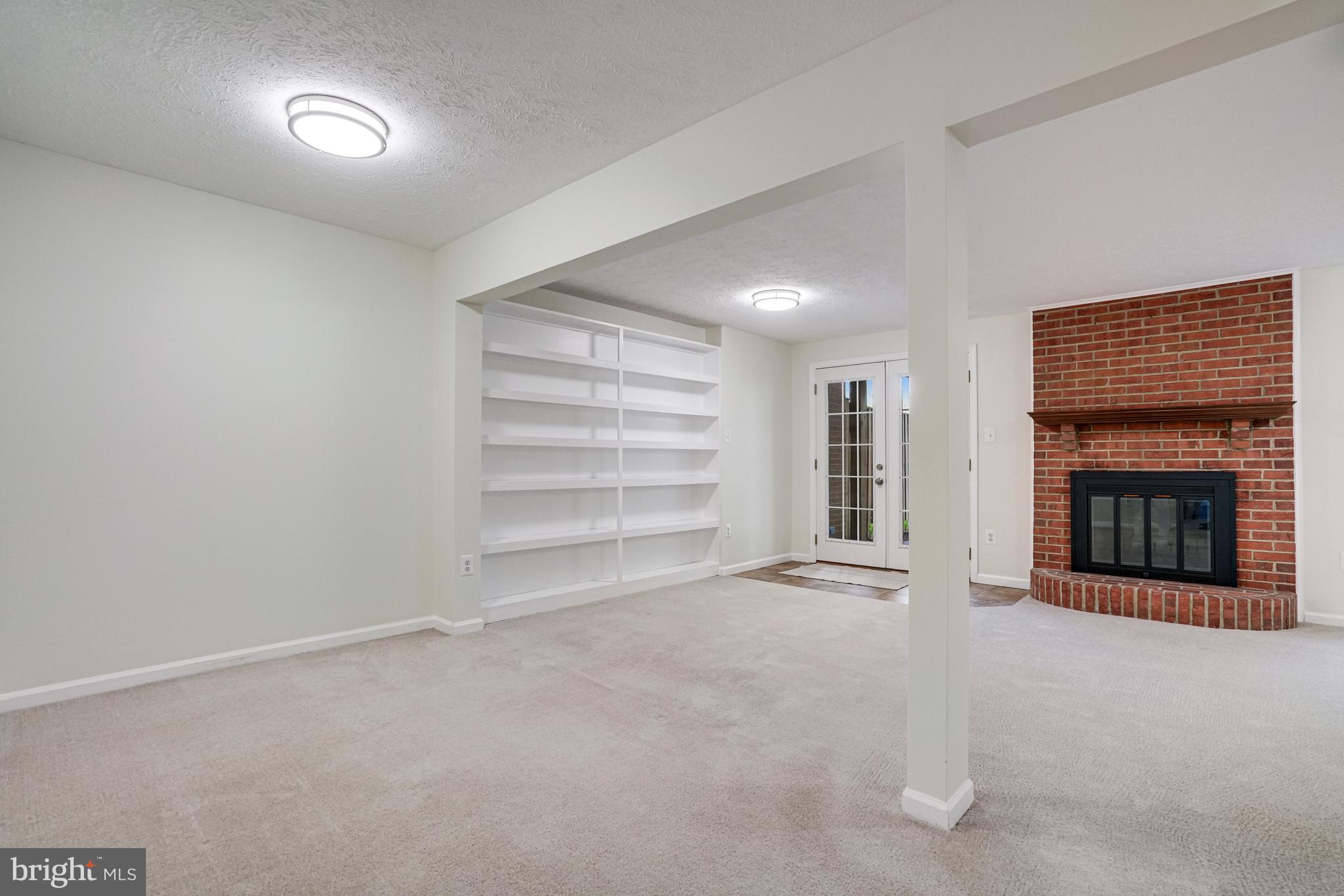 2266 Cartbridge Road Falls Church, VA 22043 - Photo 32 of 48 a view of an empty room with a fireplace and a window