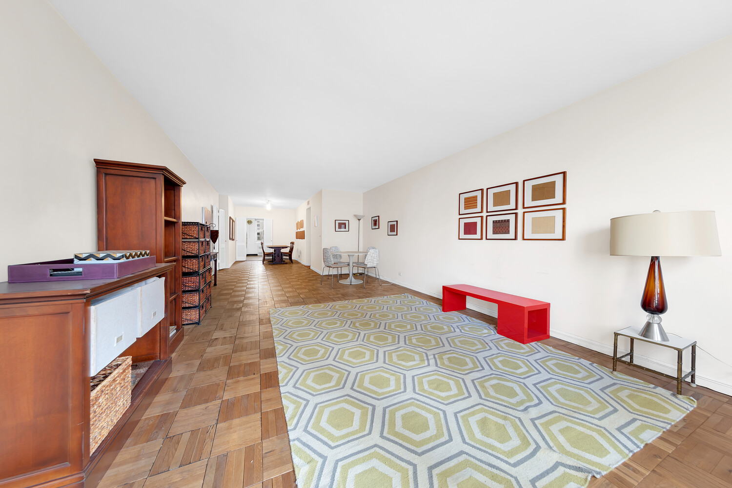 205 East 63rd Street, Unit 6G Manhattan, NY 10065 - Photo 2 of 6 a bedroom with furniture and a lamp