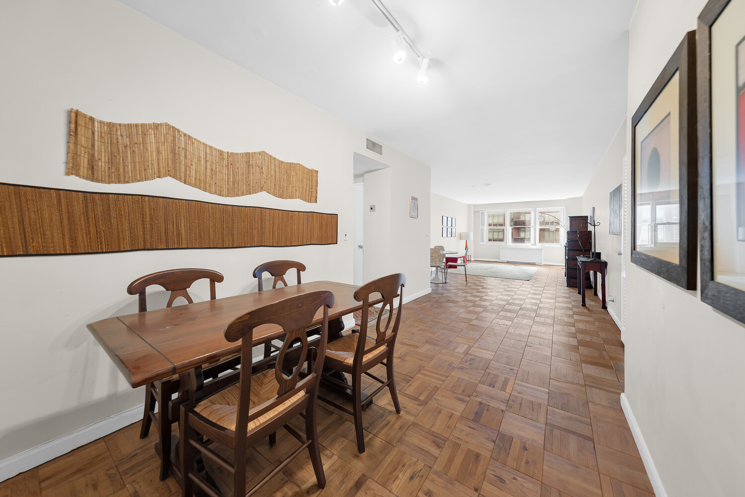 205 East 63rd Street, Unit 6G Manhattan, NY 10065 - Photo 3 of 6 a view of a dining room with furniture and a kitchen view