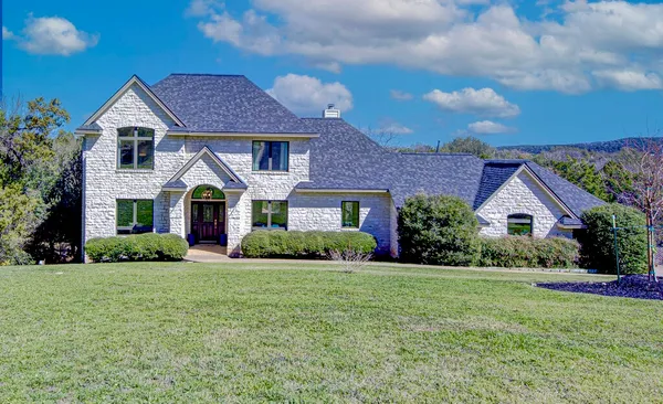 a front view of a house with a yard